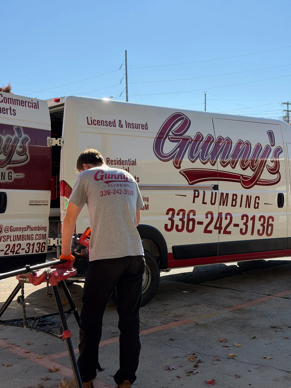 Gunny's Plumbing technician working at the service van